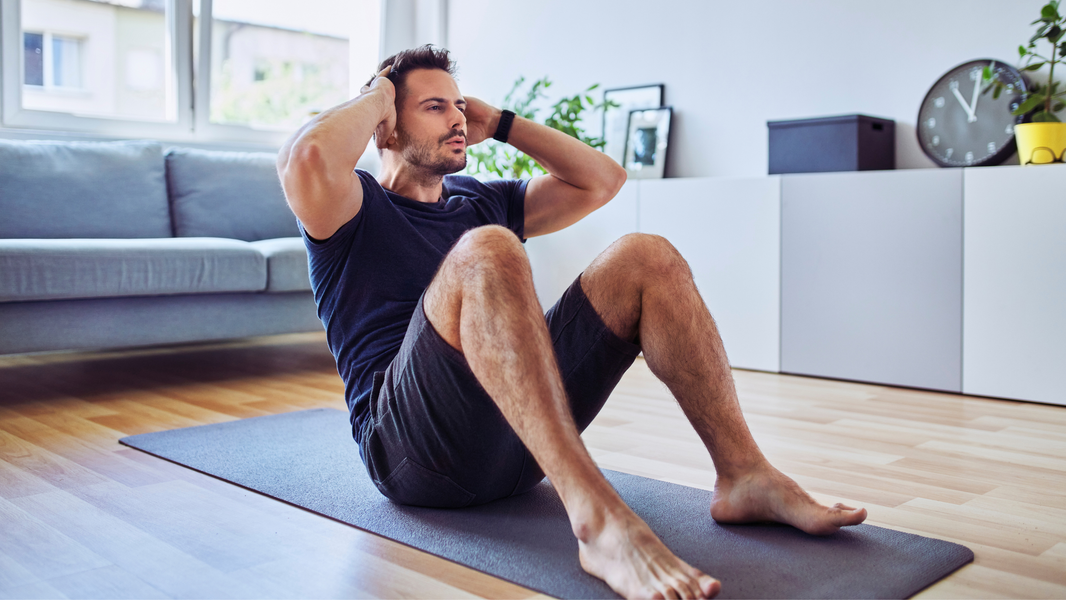 a man exercises in his living room, an example of daily routines for sobriety