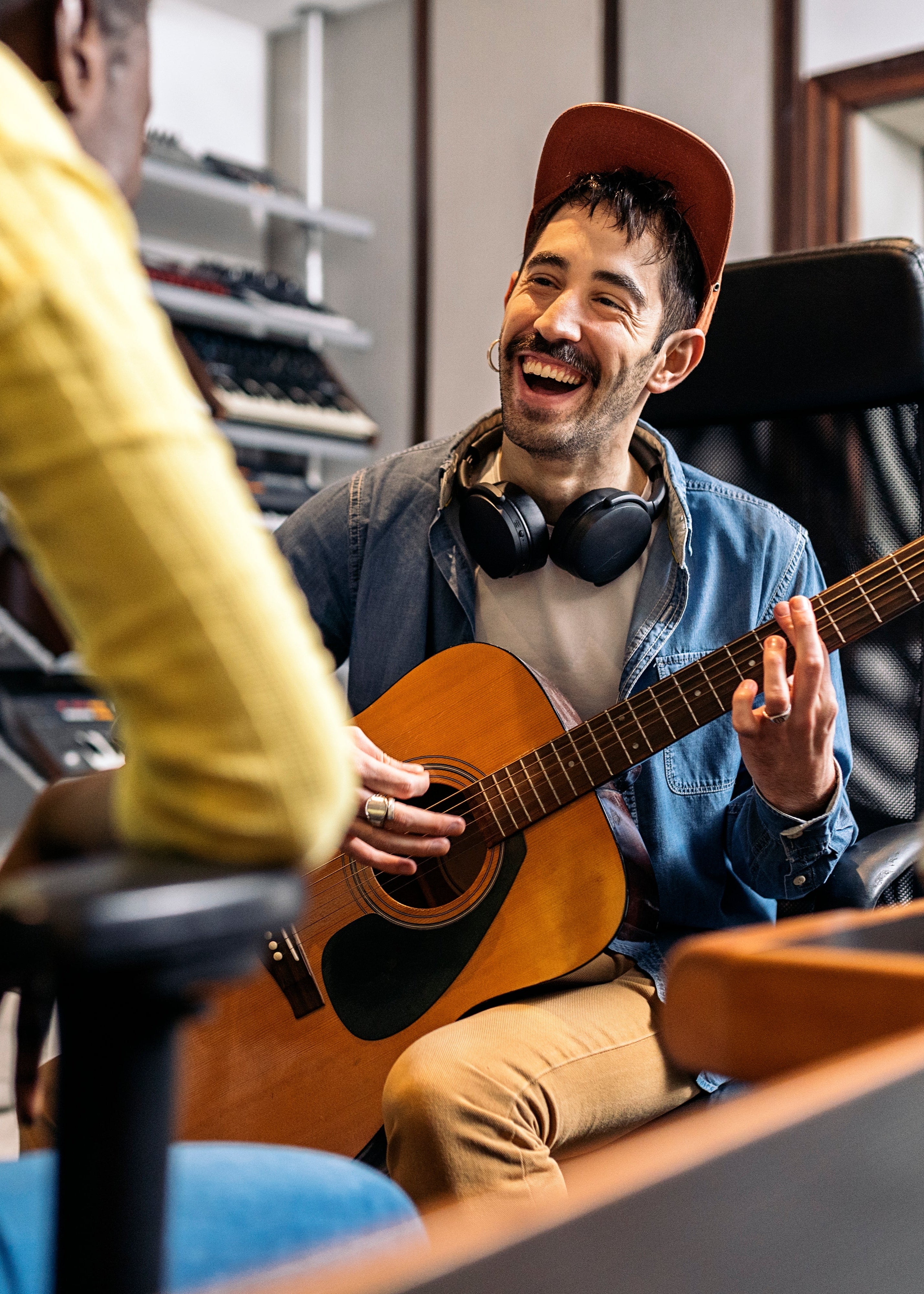 Man playing guitar in a music store celebrating being sober and detoxed